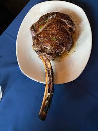 Bowdie's Chophouse signature dishes Tomahawk RibeyeBone-In Filet MignonTruffle FriesSeafood Tower